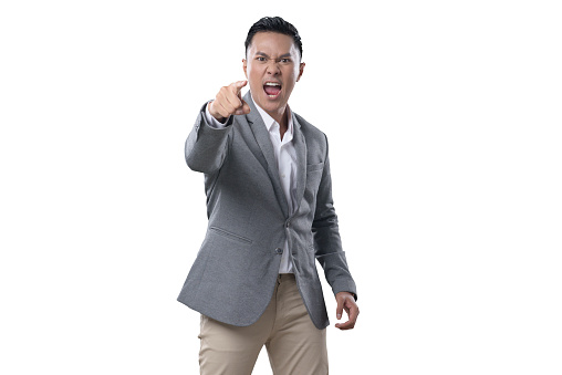 Indonesian Man on white Background looking frustrated screaming and pointing his finger outward
