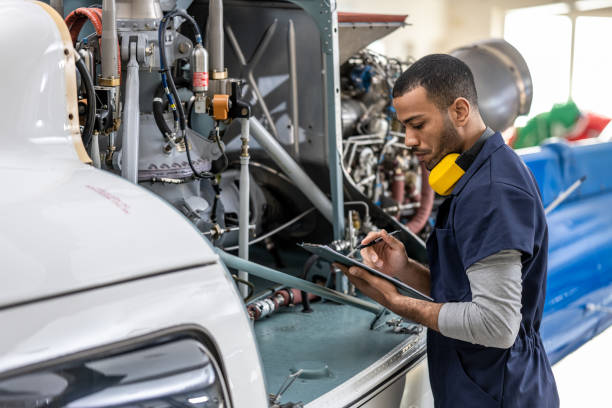 istock Male mechanic checking clipboard 1412148349