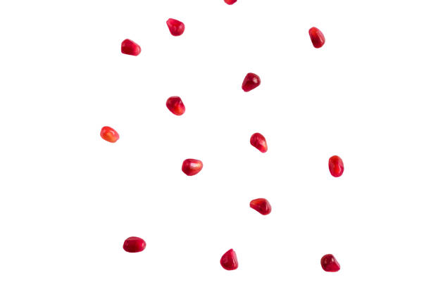 istock Falling pomegranate grains isolated on a white background 1412148829