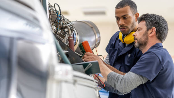 istock Mechanics repairing helicopter engine 1412148845