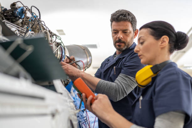 istock Mechanics repairing helicopter engine 1412148848