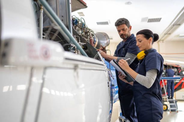 istock Mechanics repairing helicopter engine 1412148851