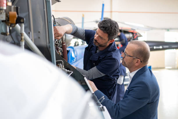 istock Mechanics repairing helicopter engine 1412148852