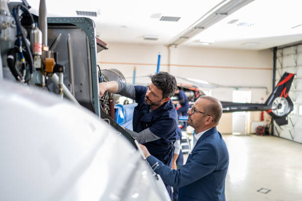 istock Mechanics repairing helicopter engine 1412148856
