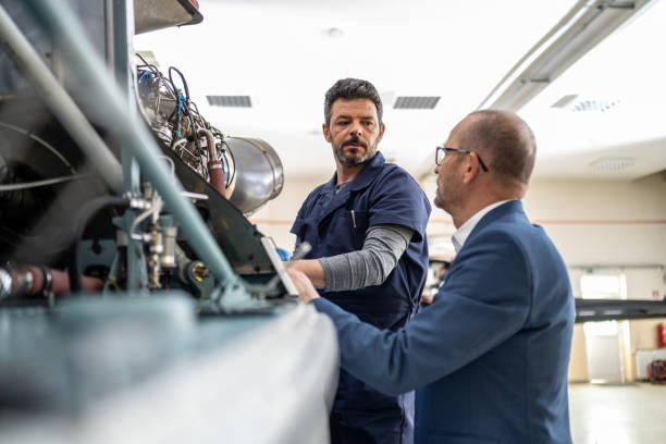 istock Mechanics repairing helicopter engine 1412148859