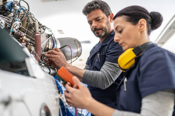 istock Mechanics repairing helicopter engine 1412148863