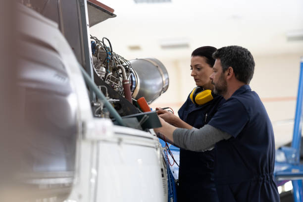 istock Mechanics repairing helicopter engine 1412148864