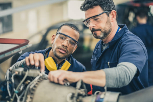 istock Mechanics repairing helicopter engine 1412148890