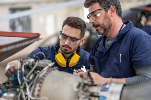 istock Mechanics repairing helicopter engine 1412148893