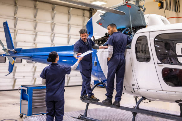 istock Group of mechanics standing on helicopter 1412148911