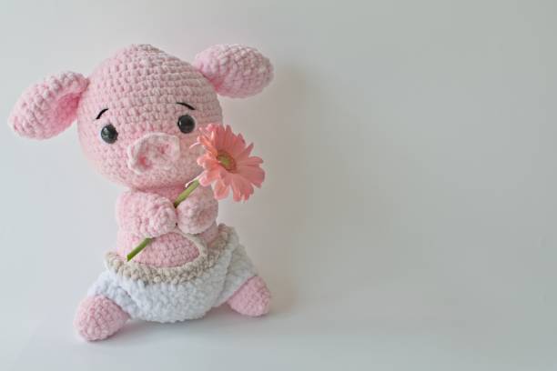 istock Soft crochet animal holding flower 1412149775