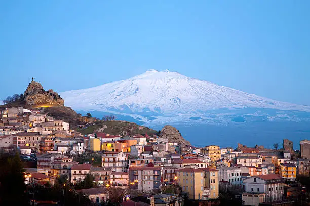 View of the village of San Teodoro and Etna volcano on background. Sicily, Italy.