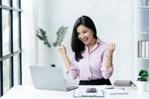 istock asian beautiful female manager working using her laptop typing in the office. 1412151530