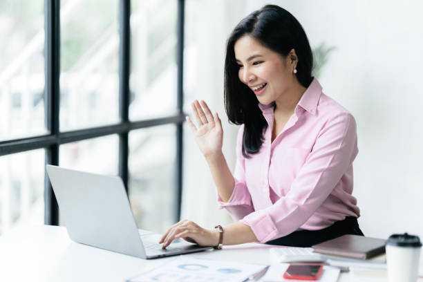 istock asian beautiful female manager working using her laptop typing in the office. 1412151778