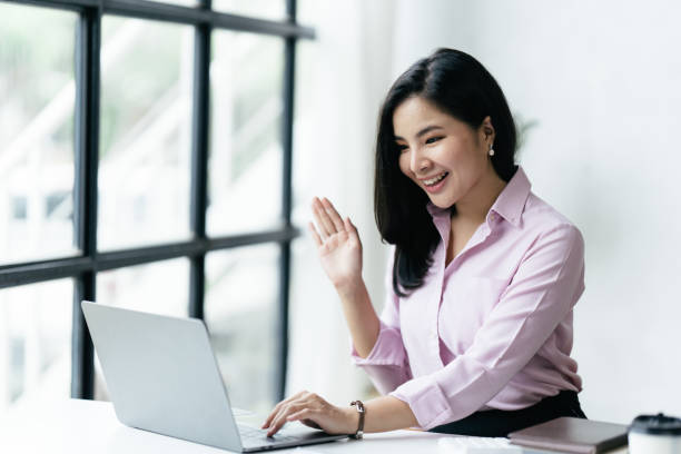 istock asian beautiful female manager working using her laptop typing in the office. 1412151874