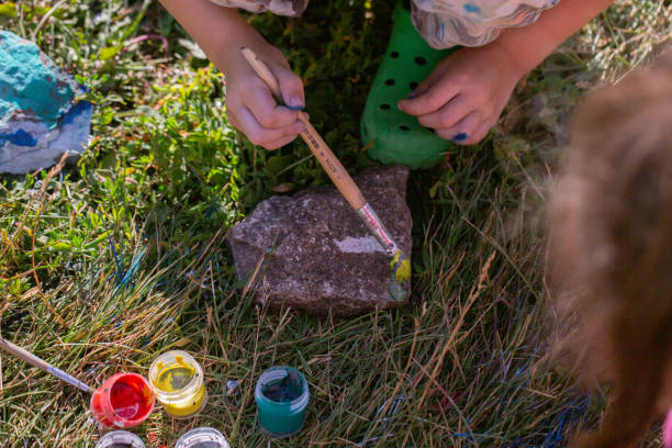 istock Children's master class painting with gouache on stones. 1412151878