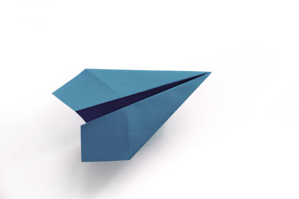 istock Blue paper plane origami isolated on a white background 1412153929