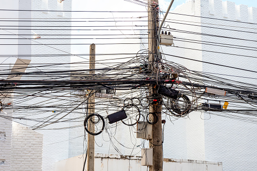 Chaos of cables and wires on electric pole in chiang mai,thailand.