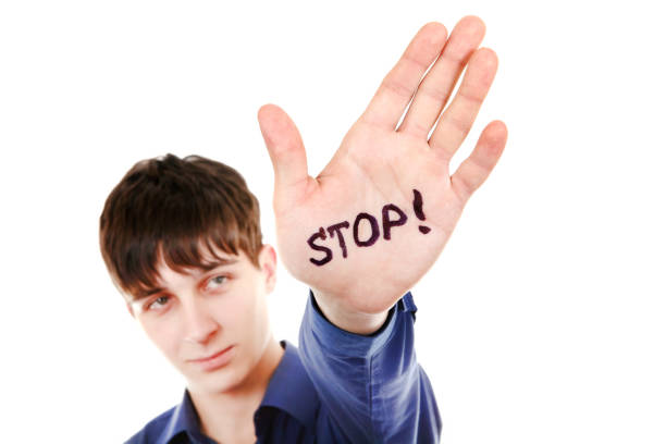 istock Young Man show a Stop Gestutre 1412154520