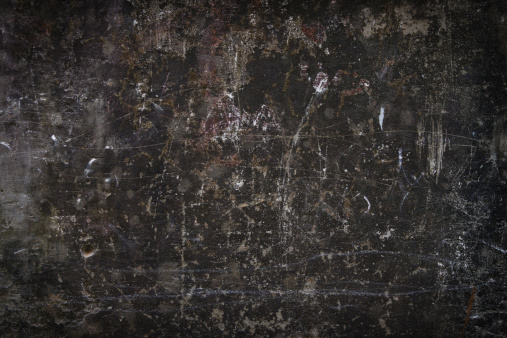 Dark background of a dirty scratched wall.