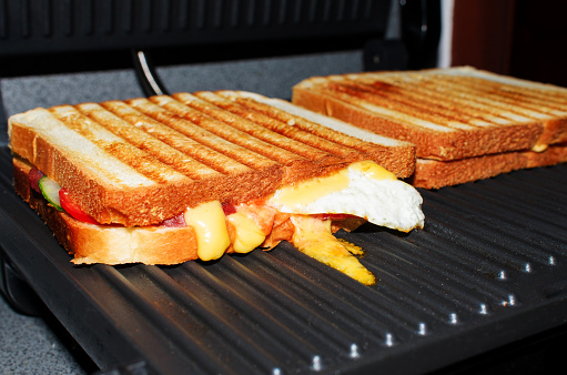Grilled sandwiches close-up. Making toast for morning breakfast