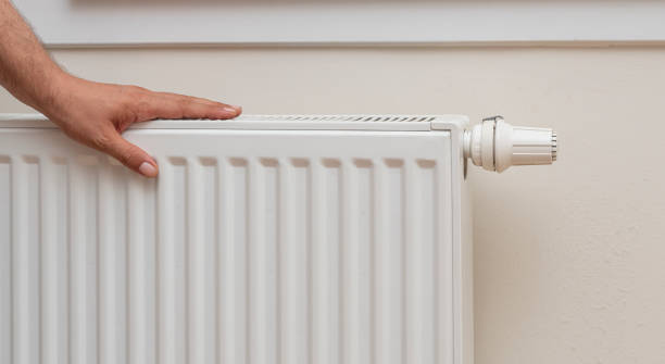 touching the radiator touching the radiator, front view radiators stock pictures, royalty-free photos & images