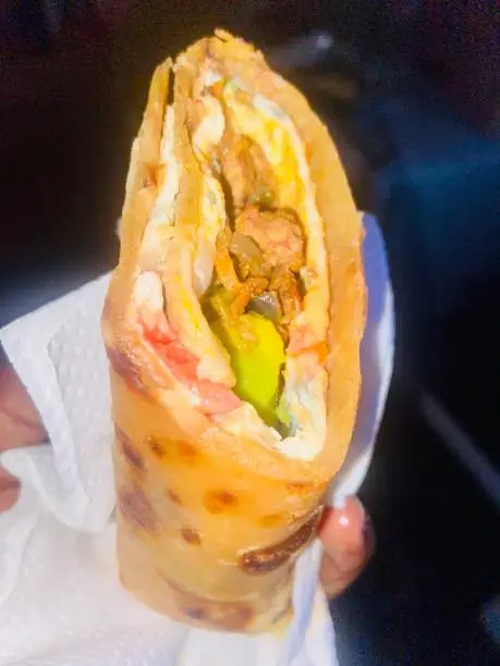 Ugandan street food comminly known as Rolex: a ugandan beef and vegetable rolex