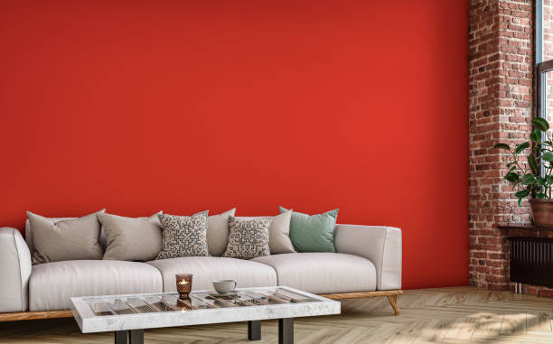 istock Empty nostalgic retro living room with beige sofa,  colored cushions, coffee table, and decoration (potted plant) in front of a colored wall and partly ruined brick wall 1412158842