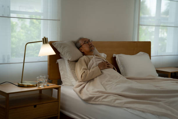 istock Retirement eldely man sick lonely laid on bed 1412159059