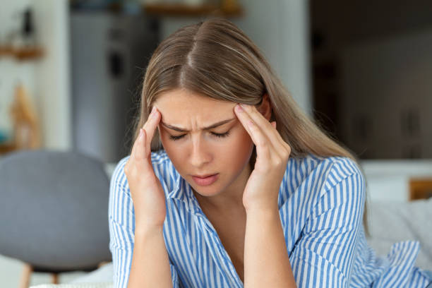 istock Sinus ache causing very paintful headache. Unhealthy woman in pain. Sharp strong sore. Sinus pain, sinus pressure, sinusitis. Sad woman holding her head because sinus pain 1412160561