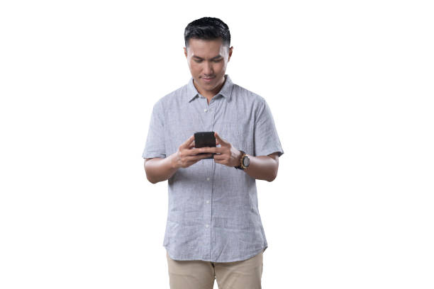 istock Indonesian Man on white Background smiling while looking at his phone 1412161721