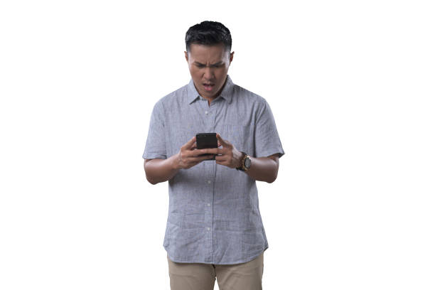 istock Indonesian Man on white Background sad while looking at his phone. 1412161768