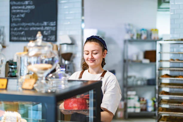 istock Baker taking strawberry cake from store counter 1412161811