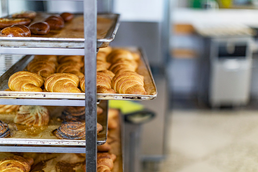 Fresh croissant cooling rack in pastry factory