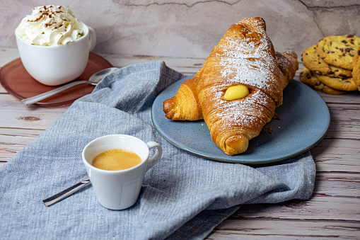 A perfect european Breakfast: Croissants, italian espresso, cookies, cappuccino.