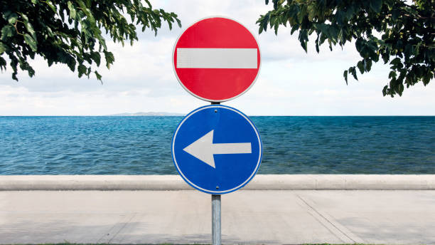istock stop sign and left turn sign 1412163405