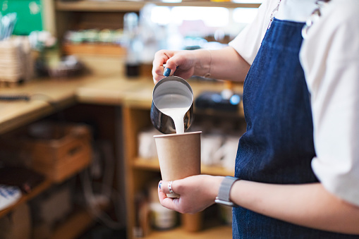 Barista making coffee in bakery cafe