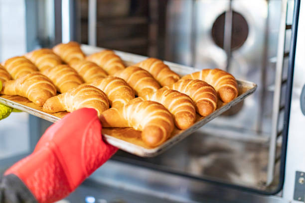 Close up of hands with buns from oven