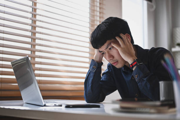 istock Serious businessman looking at laptop screen, having problems at work. Emotional pressure, stress at work concept. 1412163655