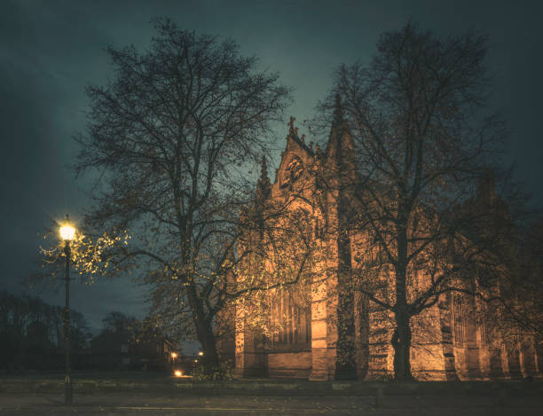 The gothic architecture of Carlisle Cathedral East Window seen from Castle Street on an atmospheric morning.