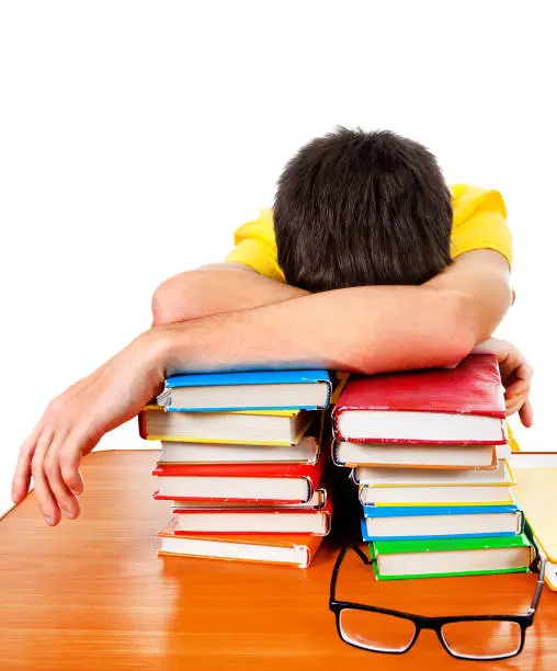 Tired Student sleep with a Books on the White Background