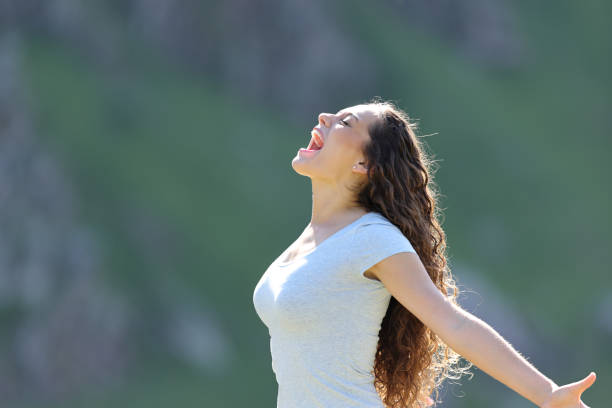 istock Excited woman screaming in the mountain 1412166579