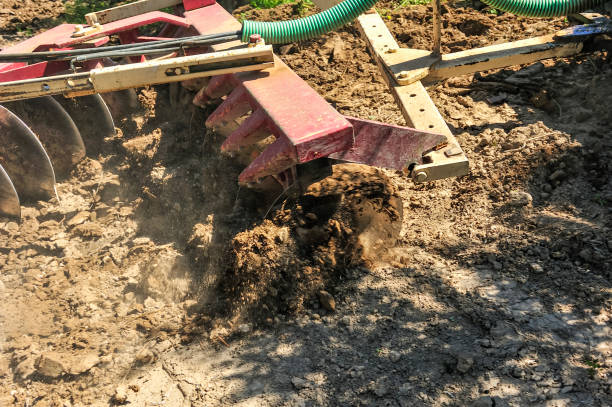 istock Tractor performing tillage tasks in the olive grove - disc harrows 1412170870