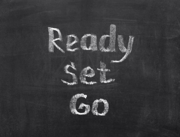 istock Words Ready, Set, Go written by chalk on a blackboard 1412173743