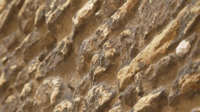 Weathered vintage stone wall. Grunge texture of historical antique medieval cathedral