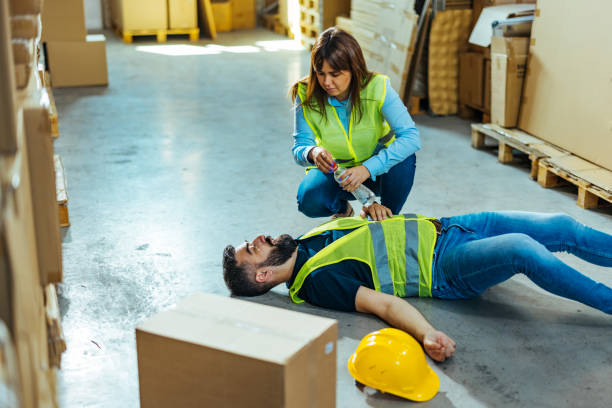 istock Warehouse worker frist aid after accident 1412175201