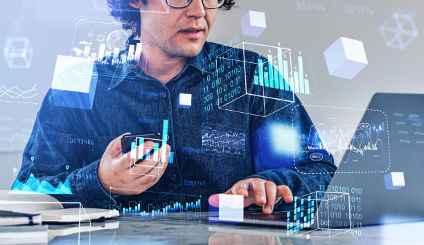 istock Businessman with laptop and phone, data blocks in cyberspace, financial data 1412175442
