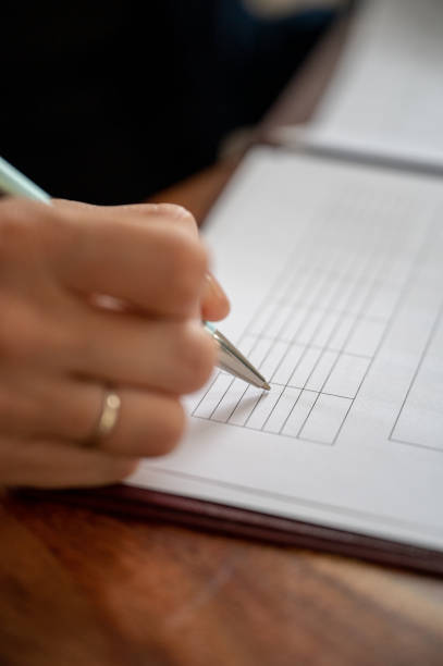 istock Businesswoman filling data in a table 1412175464