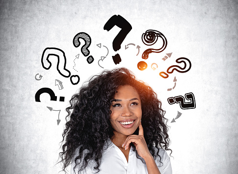 Young woman is looking up with question marks