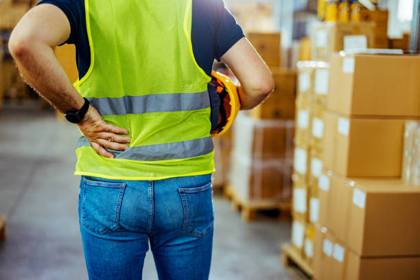 istock Shot of a young man experiencing back pain while working 1412175791